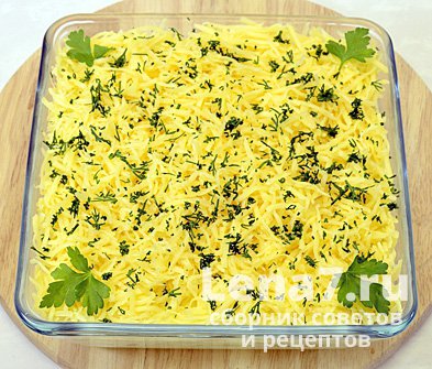 Готовый салат, посыпанный сыром и зеленью